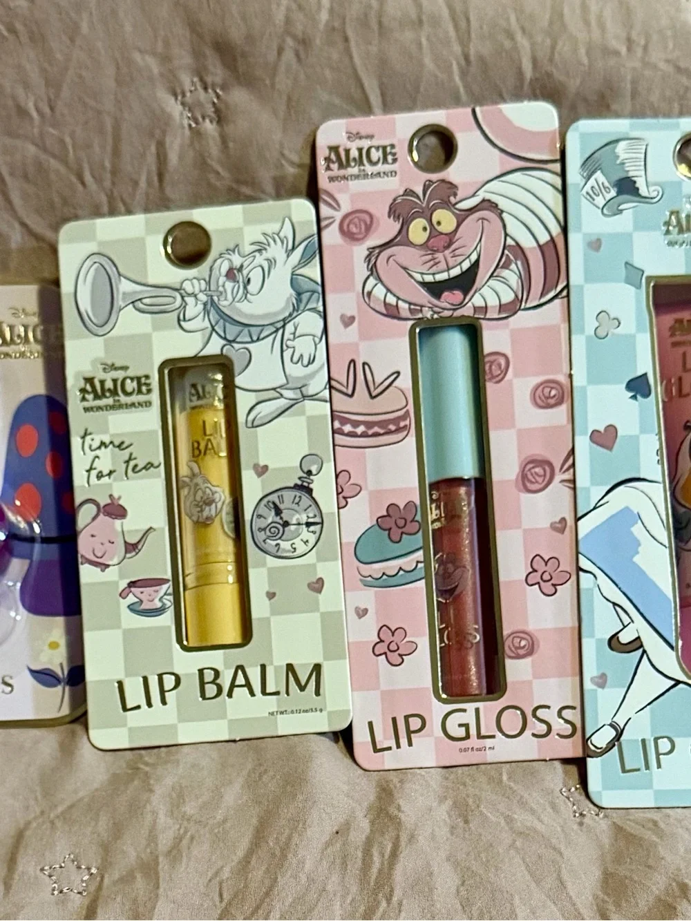 4 piece Alice in Wonderland Lip Gloss & Balm Set - Purple, Gold, Pink, Blue